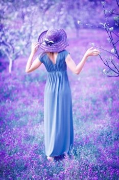 Dreamy, fine art photo of seductive woman in fairy garden, romantic girl in elegant long dress on purple lavender field, sensual nymph in the forest