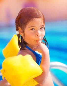 Closeup portrait of cute little arabic girl having fun in poolside, relaxation outdoors, enjoying summertime, pleasure and enjoyment concept