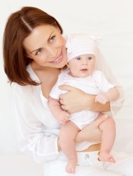 Closeup portrait of beautiful young woman holding on hands little daughter, at home, happy parenthood, new life concept
