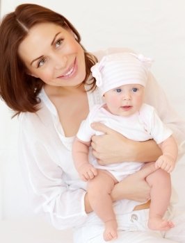 Closeup portrait of cute young mother holding sweet newborn baby, at home, happy family, love and new life concept