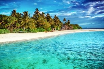 Beautiful paradise beach, luxury tropical resort, turquoise transparent sea around the island with fresh green palm trees on the coast, summer vacation on Maldives, Asia