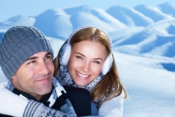 Closeup portrait of cheerful smiling couple in the winter park, having fun in the mountains, happy wintertime holidays