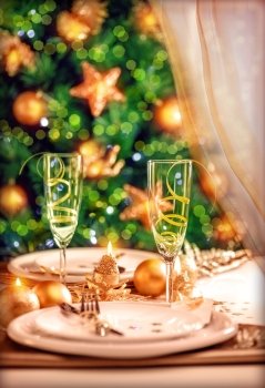 Christmas table setting, festive dinner still life and beautiful decorated Xmas tree at home, New Year eve, luxury wintertime party concept