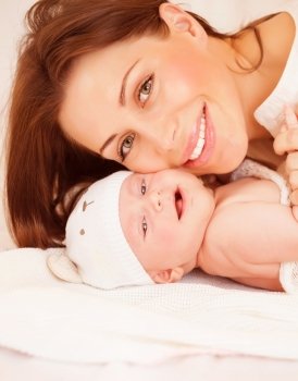 Closeup portrait of sweet newborn baby with pretty mom, healthy childhood, young family, happy motherhood, tenderness and love concept