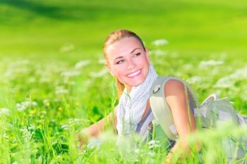 Portrait of cute female sitting on floral field, happy traveler with backpack resting outdoors, summer vacation concept