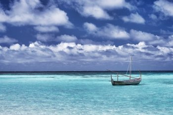 Little boat in the sea, fishing in warm sunny day, beautiful landscape, amazing travel destination, summer vacation on Maldives, Asia