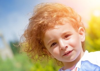 Closeup portrait of sweet adorable child outdoors, have fun in the park, relaxation on backyard, active childhood, happiness concept