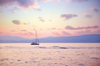 Luxury sailboat in beautiful pink sunset light on the sea, amazing view, luxury water transport, summer vacation concept
