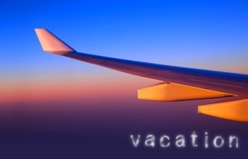 Plane wing in sunset light, line of horizon, air space, luxury transportation, travelling and vacation concept