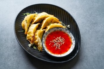 Steamed gyozas with teriyaki sauce and sesame seeds