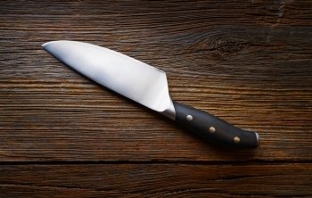 Chef knife on a wooden background texture