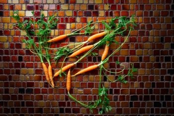 Mini Carrot vegetables on a tiles table background