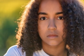 Beautiful mixed race African American girl teenager female young woman sad depressed or thoughtful 