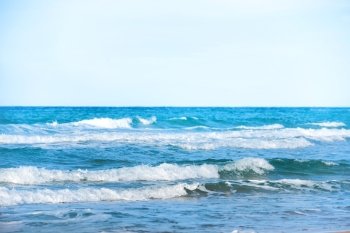 Waves on the blue sea water at a beach