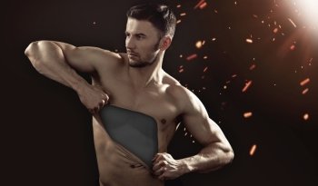 Muscular guy pulling his chest skin away