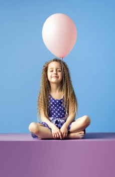 Relaxed little girl holding a balloon
