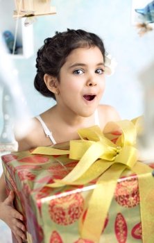 Surprised cute girl with birthday gifts