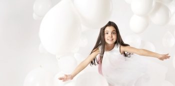 Cute little girl playing white balloons