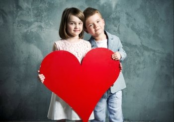 Two kids holding a giant paper heart