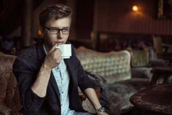 Smart guy drinking an aromatic coffee