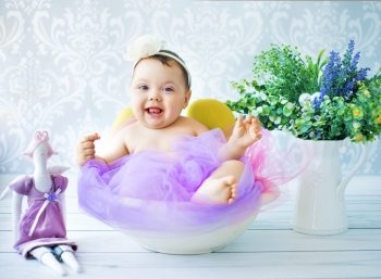 Cute baby playing in the colorful room