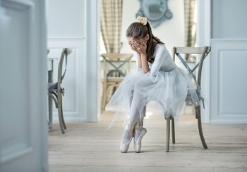 Sad ballet dancer crying in the cloak room