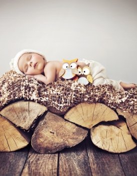 Portrait of a  toddler sleeping on wood 