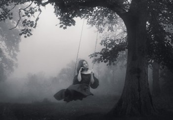 Art portrait of a young lady on a retro swing