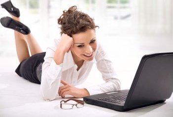 Pretty, young businesswoman resting with a laptop
