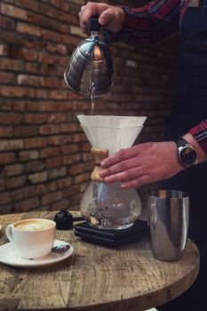 Barista brewing coffee. Barista brewing coffee in chemex in the cafe