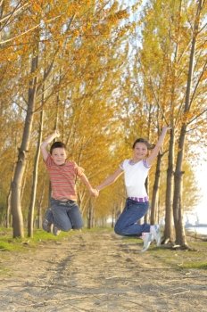 Happy active children jumping in forest