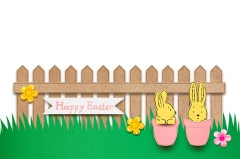 Creative easter concept photo of rabbits in flower pots in front of the fence made of paper on white background.