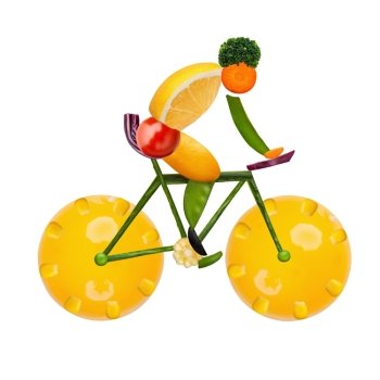 Healthy food concept of a male cyclist on a road bike made of fresh vegetables and fruits, isolated on white.