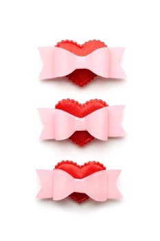Creative valentines concept photo of hearts with bows on white background.