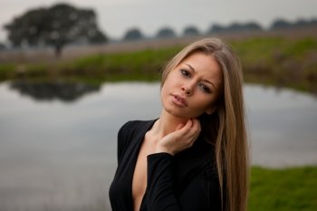 Attractive girl with sexy black shirt in the field
