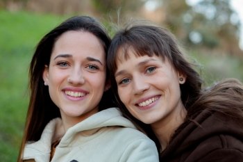 Nice sisters with blue eyes in a park