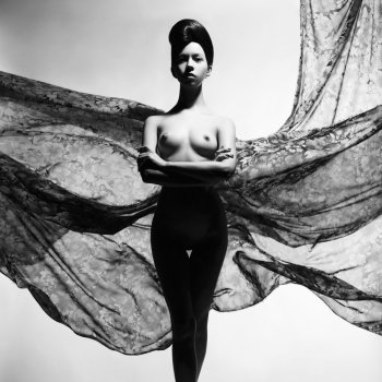 Black and white art fashion studio photo of nude elegant woman surrounded by flowing draperies. Perfect body. Beauty and health