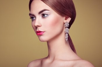 Fashion portrait of young beautiful woman with jewelry. Blonde girl. Perfect make-up and hairstyle.  Beauty style woman with diamond accessories. Silver earrings