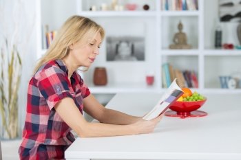 senior woman reading a book at homerelaxing time
