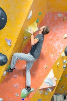 young man practising climbing