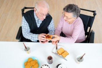disabled old couple preparing having breakfast