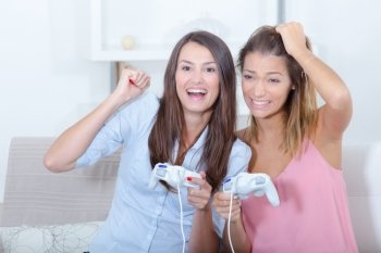two girl-friends playing video games