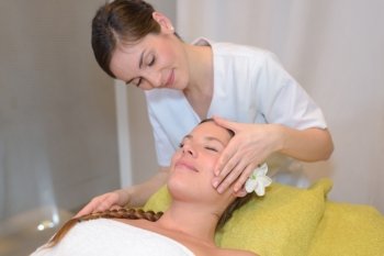 young healthy happy woman in spa making treatments