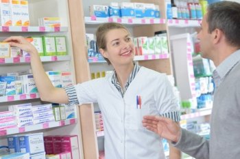 professional pharmacist helping a customer