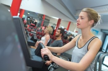 fit blonde using the step machine at the gym