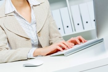 Close up of woman's hands working in office on computer