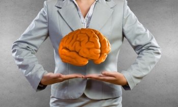Human mind. Businesswoman presenting in palms brain or save intelligence concept