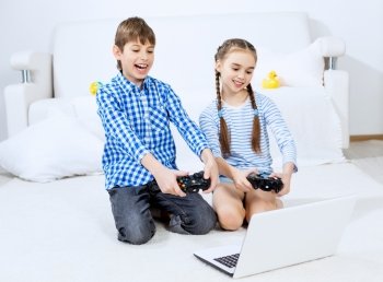 Kids playing game console. Cute kids sitting on floor playing games on joystick