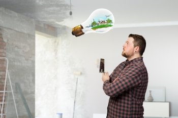 Home renovation and improvement. Man in checked shirt indoors with spatula in hand