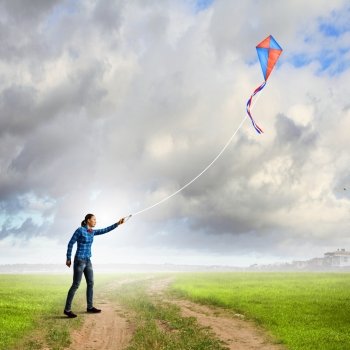 Woman with kite. Young woman in casual playing with kite